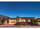 Contemporary home featuring clean lines, stylish garage door, desert landscaping, and warm exterior lighting at 461 Highview Ridge Ave, Las Vegas, NV 89138
