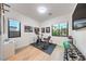 Well-lit home gym with exercise bike, weights, weight bench and multiple windows at 461 Highview Ridge Ave, Las Vegas, NV 89138