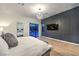 Spacious primary bedroom featuring light wood floors and sliding glass doors to the pool at 461 Highview Ridge Ave, Las Vegas, NV 89138