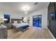 Modern bedroom with a king-size bed, blue bench, and sliding glass doors to the pool area at 461 Highview Ridge Ave, Las Vegas, NV 89138