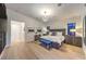 Bright primary bedroom featuring light wood floors, contemporary lighting, and modern decor at 461 Highview Ridge Ave, Las Vegas, NV 89138
