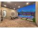Outdoor covered patio with a pool table and an in-ground pool, with mountain views at dusk at 461 Highview Ridge Ave, Las Vegas, NV 89138