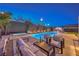 Backyard with a pool, spa, and outdoor kitchen with a bar for entertaining guests at 461 Highview Ridge Ave, Las Vegas, NV 89138
