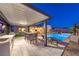 Outdoor living area with a covered kitchen, dining, lounge, and stunning pool at 461 Highview Ridge Ave, Las Vegas, NV 89138