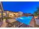 Entertainer's backyard featuring a pool, spa, and outdoor kitchen with poolside lounge seating at 461 Highview Ridge Ave, Las Vegas, NV 89138