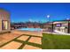 Backyard oasis featuring a sparkling pool, spa, and outdoor kitchen with bar seating at 461 Highview Ridge Ave, Las Vegas, NV 89138