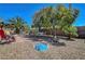 Well-maintained backyard with a tiled patio, lounge chairs, and mature landscaping providing a private retreat at 4802 Regalo Bello St, Las Vegas, NV 89135