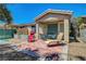 Inviting backyard with tiled patio, lounge chairs, and dining set, perfect for outdoor relaxation and entertaining at 4802 Regalo Bello St, Las Vegas, NV 89135