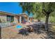 Relaxing backyard featuring a patio, dining table, mature trees, and ample space for outdoor enjoyment at 4802 Regalo Bello St, Las Vegas, NV 89135