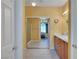 Bathroom with double sinks, wood cabinets, tile floors, and a sliding mirror door closet at 4802 Regalo Bello St, Las Vegas, NV 89135