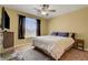 Cozy bedroom with a ceiling fan and natural light showcasing a peaceful retreat at 4802 Regalo Bello St, Las Vegas, NV 89135