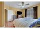 Comfortable bedroom with wood floors, ceiling fan and natural light from the window at 4802 Regalo Bello St, Las Vegas, NV 89135