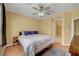 Comfortable bedroom with a ceiling fan and a view to the ensuite bathroom creating a serene atmosphere at 4802 Regalo Bello St, Las Vegas, NV 89135
