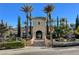 Elegant clubhouse exterior with grand entrance, mature landscaping, and convenient golf cart parking at 4802 Regalo Bello St, Las Vegas, NV 89135