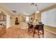 Charming dining area features a marble-top table set adjacent to a modern kitchen with wood flooring at 4802 Regalo Bello St, Las Vegas, NV 89135
