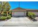 Attractive home boasts a wide driveway, a two-car garage and manicured landscaping at 4802 Regalo Bello St, Las Vegas, NV 89135