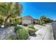 Landscaped home shows shrubbery, rock accents, and a driveway leading to a two-car garage at 4802 Regalo Bello St, Las Vegas, NV 89135