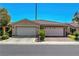 Close up of a home with a two-car garage, a neutral color scheme, and a tile roof at 4802 Regalo Bello St, Las Vegas, NV 89135
