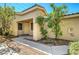 A covered front porch with a white door, small garden area, and a neutral color scheme at 4802 Regalo Bello St, Las Vegas, NV 89135