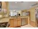 Open concept kitchen featuring granite countertops, stainless steel appliances and breakfast bar seating at 4802 Regalo Bello St, Las Vegas, NV 89135