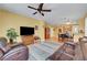 Spacious living room with stylish furniture and decor, connecting seamlessly with the kitchen and dining area at 4802 Regalo Bello St, Las Vegas, NV 89135