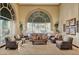 Comfortable lounge area with natural light from large windows, neutral decor and garden view at 4802 Regalo Bello St, Las Vegas, NV 89135