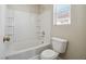 Bathroom featuring white tile, tub and shower with shelving at 4830 Double Down Dr # 102, Las Vegas, NV 89122