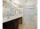 Bright bathroom featuring a glass shower and double sinks with modern fixtures at 4830 Double Down Dr # 102, Las Vegas, NV 89122