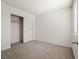 A cozy bedroom features neutral carpet, white walls, closet with sliding doors, and a bright window at 4830 Double Down Dr # 102, Las Vegas, NV 89122
