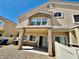 A two-story townhouse features a covered patio and desert landscaping at 4830 Double Down Dr # 102, Las Vegas, NV 89122