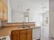 Kitchen with wood cabinets and a view of the living room at 4830 Double Down Dr # 102, Las Vegas, NV 89122