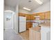 Bright kitchen featuring wood cabinets, a white refrigerator, and tile flooring at 4830 Double Down Dr # 102, Las Vegas, NV 89122