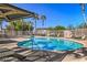 Outdoor pool is surrounded by palm trees and lounge seating on a sunny day at 4830 Double Down Dr # 102, Las Vegas, NV 89122