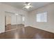 Bright bedroom features wood floors, mirrored closet doors, and a ceiling fan at 5250 S Rainbow Blvd # 2183, Las Vegas, NV 89118