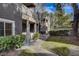 Exterior view of a multi-story condo building with well-maintained landscaping, bushes, and sidewalk at 5250 S Rainbow Blvd # 2183, Las Vegas, NV 89118