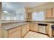 Open kitchen view to living room, featuring granite counters and appliances at 5250 S Rainbow Blvd # 2183, Las Vegas, NV 89118