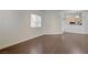 Bright and airy living room showcasing hardwood floors and a view into the adjacent kitchen at 5250 S Rainbow Blvd # 2183, Las Vegas, NV 89118