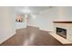 Expansive living space with hardwood flooring, fireplace and view into the kitchen area at 5250 S Rainbow Blvd # 2183, Las Vegas, NV 89118