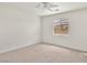 Bright bedroom with a ceiling fan, window with blinds, and carpet at 5373 Blue Oat Ave, Las Vegas, NV 89141