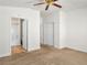 Spacious bedroom with a ceiling fan, carpet, and an en suite bathroom at 5373 Blue Oat Ave, Las Vegas, NV 89141