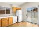 Bright kitchen featuring tile flooring, wooden cabinets, and access to the backyard at 5373 Blue Oat Ave, Las Vegas, NV 89141