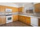 Well-appointed kitchen with wooden cabinets, tile backsplash, and plenty of counter space at 5373 Blue Oat Ave, Las Vegas, NV 89141