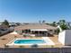 Backyard showcases a pool, hot tub, covered patio, and desert-friendly landscaping, creating a serene outdoor retreat at 5450 Grain Mill Rd, Pahrump, NV 89061