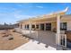 Outdoor patio area with cover, outdoor seating, and views of the backyard at 5450 Grain Mill Rd, Pahrump, NV 89061