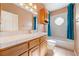 Bright bathroom features a white tiled shower and a wood cabinet vanity with solid surface countertop at 5450 Grain Mill Rd, Pahrump, NV 89061