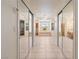 Hallway view of bathroom featuring tile flooring, dual closets, vanities, and garden tub at 5450 Grain Mill Rd, Pahrump, NV 89061