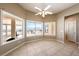 Bright bonus room features tile floors and large picture windows overlooking outdoor pool and mountain views at 5450 Grain Mill Rd, Pahrump, NV 89061