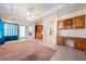 Large bonus room with a built-in desk and shelving with view to the backyard at 5450 Grain Mill Rd, Pahrump, NV 89061