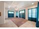 Spacious bonus room featuring carpeted floor, ceiling fan, and natural light from the windows at 5450 Grain Mill Rd, Pahrump, NV 89061