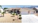 Beautiful home featuring a three-car garage, desert landscaping, and proximity to scenic mountain views at 5450 Grain Mill Rd, Pahrump, NV 89061